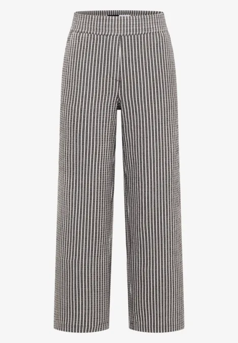 Pantalon large à rayures verticales noir et blanc, taille haute.