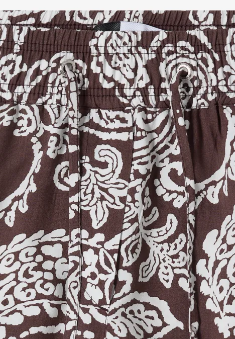 Brauner Stoff mit weißem, verspieltem Blumenmuster und elastischem Bund