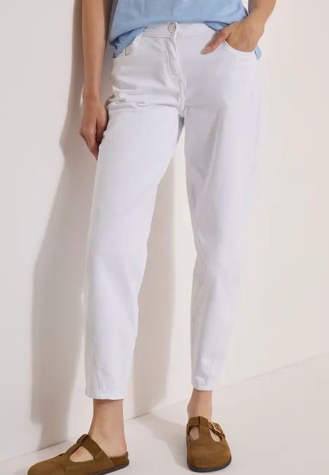 Jean taille haute à Barrel Leg, coupe ample White Bas d'une personne en jean blanc et mocassins marron sur fond neutre.