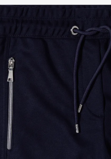 Pantalon taille mi-haute, coupe Slim Leg et style décontracté urban dark blue Dunkelblaue Jogginghose mit Kordelzug und Reißverschlusstasche.
