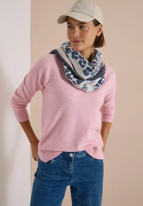 Foulard triangulaire à motif léopard dark navy blue Frau in rosa Pullover, Jeans, Cap und blau-weiß gemustertem Schal
