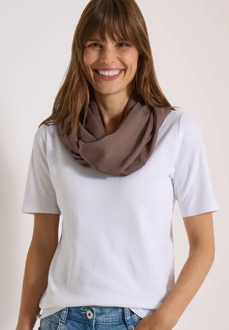 Écharpe Loop unie urban taupe Femme souriante portant un t-shirt blanc et un snood taupe sur fond clair.