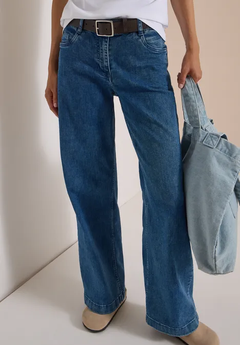 Basic Gürtel mit quadratischer Schnalle Dark Brown Person trägt weite blaue Jeans mit Gürtel und hält eine hellblaue Jeans-Tasche.
