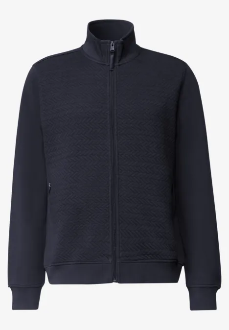 Veste bleu marine matelassée à fermeture éclair, col montant, manches longues et poches latérales.