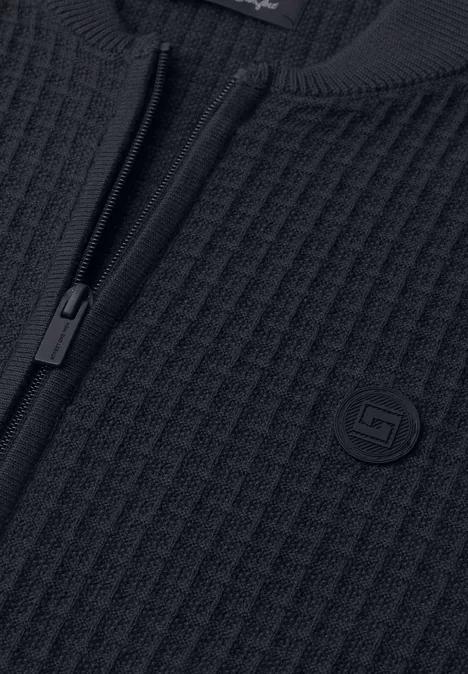 Pull en maille noir à fermeture éclair et structure gaufrée.