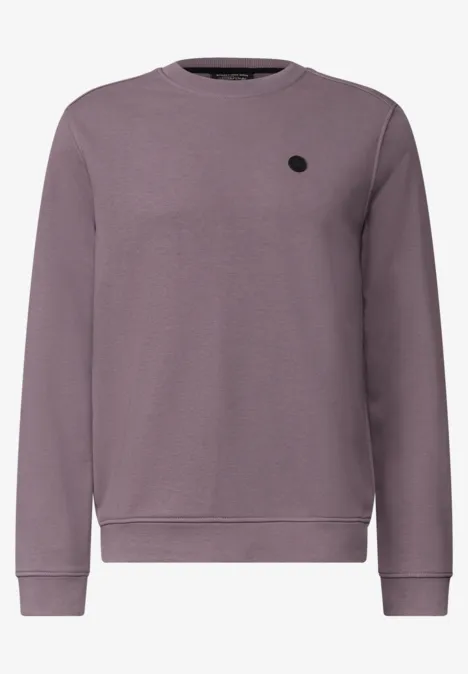 Lila Sweatshirt mit Rundhalsausschnitt, langen Ärmeln, Rippbündchen und kleinem schwarzem Logo-Patch auf der Brust.