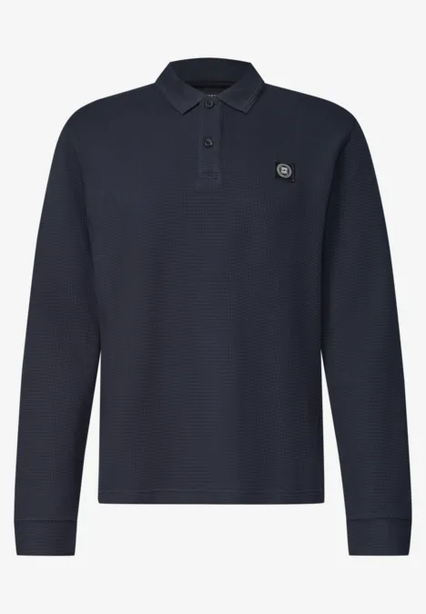 Langarm Poloshirt in Waffelstruktur dark ink blue Dunkelblaues Langarm-Polo mit Polokragen und dezentem Logopatch auf der Brust.