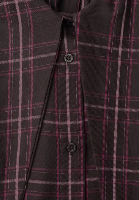 Gros plan d'une chemise à carreaux noire avec des lignes violettes et des boutons.