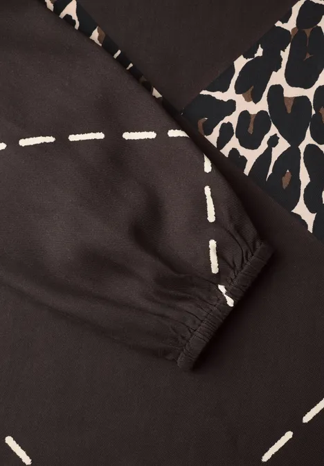 Dunkles Oberteil mit weißen Naht-Prints und Leopardenmuster