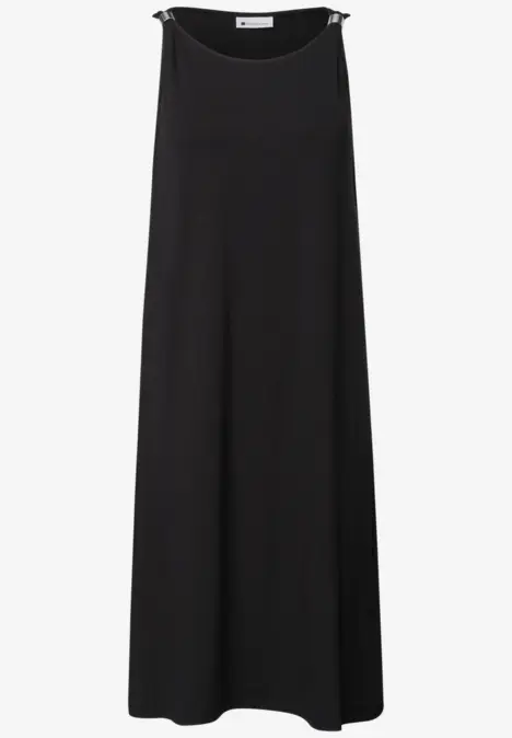 Schlichtes, ärmelloses, schwarzes, bodenlanges Kleid aus fließendem Stoff.