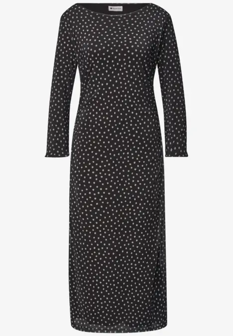 Schwarzes midi-langes Damenkleid mit weißen Punkten, Rundhalsausschnitt und langen Ärmeln.