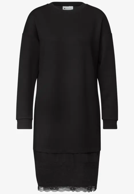 Robe pull noire à manches longues avec bord en dentelle discrète.
