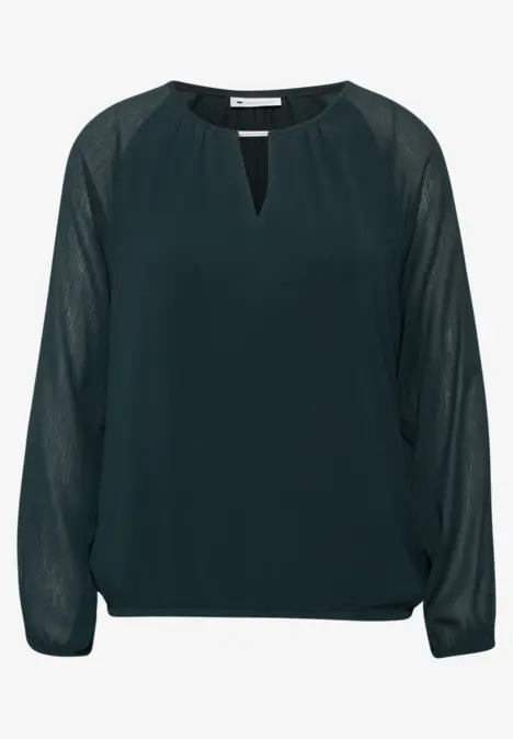Blouse vert foncé en chiffon, manches longues transparentes et encolure fendue.