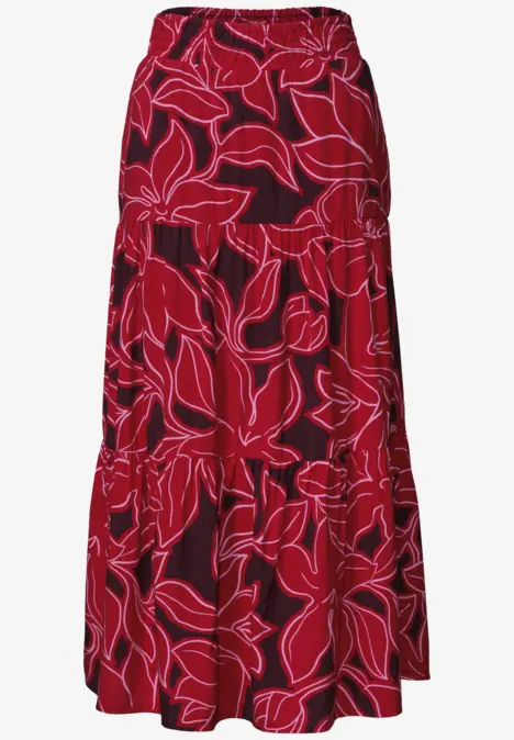 Ein roter, knöchellanger Rock mit einem großen, weißen Blumenmuster.