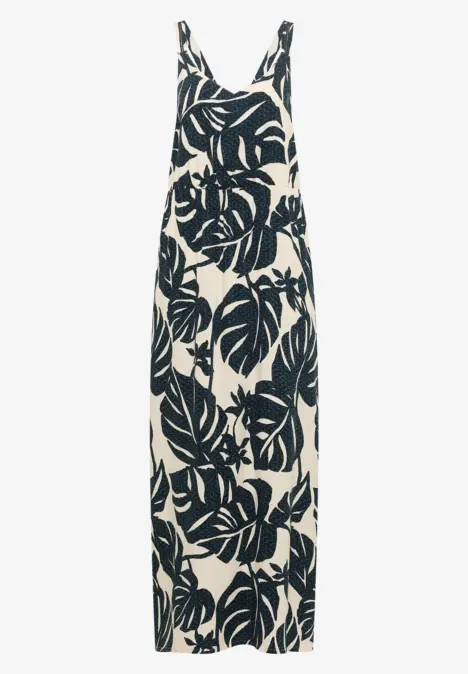 Ärmelloses Maxikleid mit dünnen Trägern und großem dunkelgrünem Monstera-Blättermuster auf cremegrund.