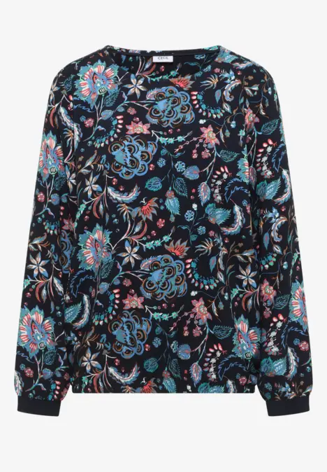 Chemisier sombre à motif paisley et floral coloré, manches longues et col rond.