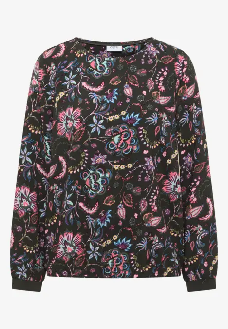 Blouse noire à motif floral coloré, manches longues et col rond.