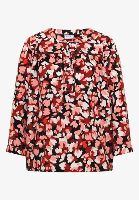 Rote, locker geschnittene Bluse mit abstraktem Blumenmuster in Weiß und Rosa.
