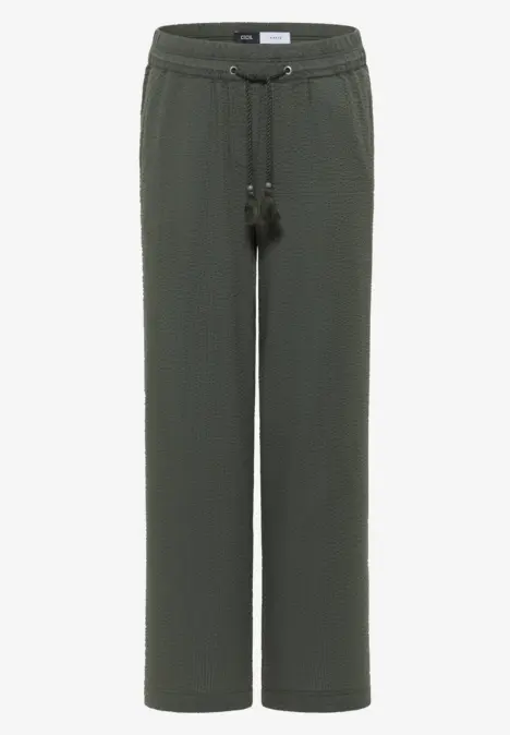 Dunkelgrüne, gerade geschnittene Hose mit elastischem Bund und Kordelzug mit Quasten.
