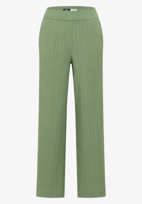 Grüne, gerippte Stoffhose mit weitem Bein.
