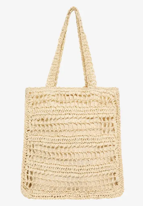 Eine beige gehäkelte Stroh-Tasche mit langen Henkeln, rechteckig und luftig gewebt.